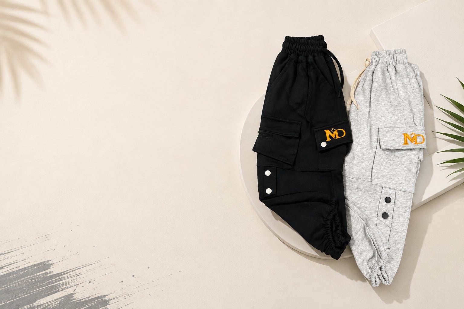 Black and grey cargo joggers, folded flat