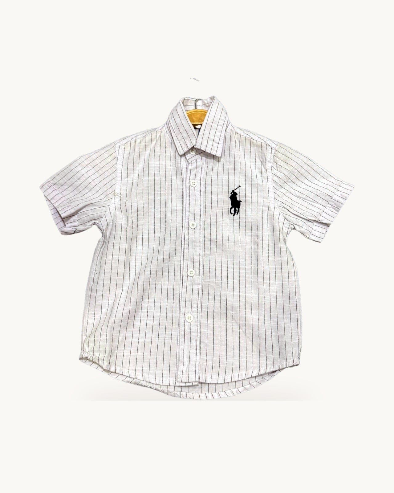 White and pink striped shirt on a hanger