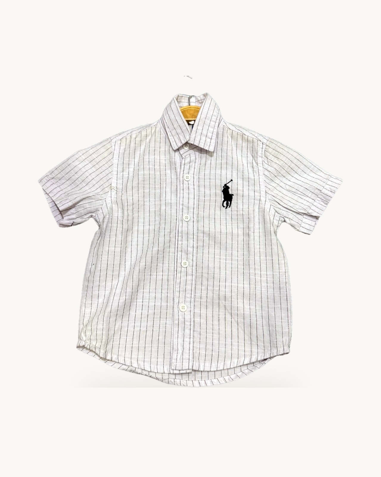 White and pink striped shirt on a hanger
